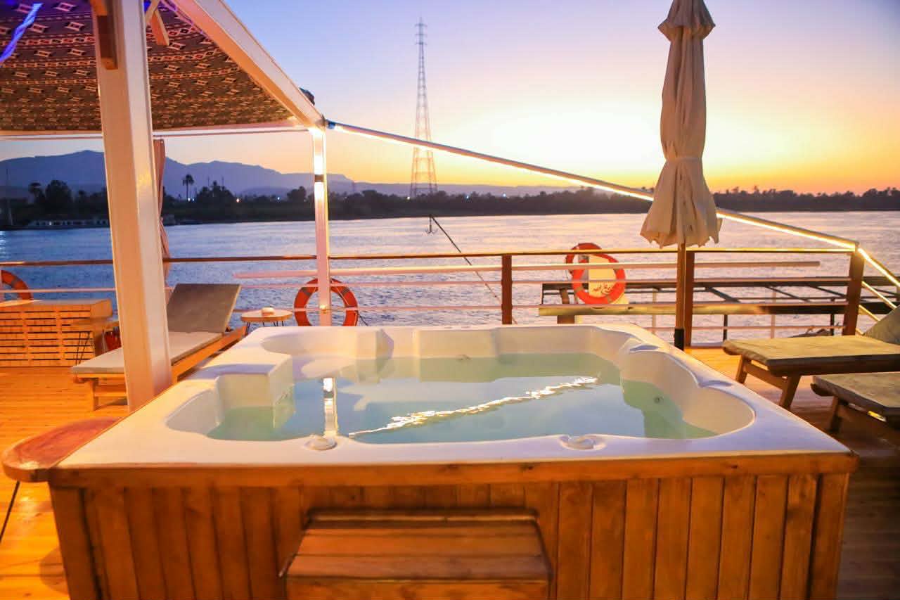 Jacuzzi on the dahabiya deck at sunset over the Nile
