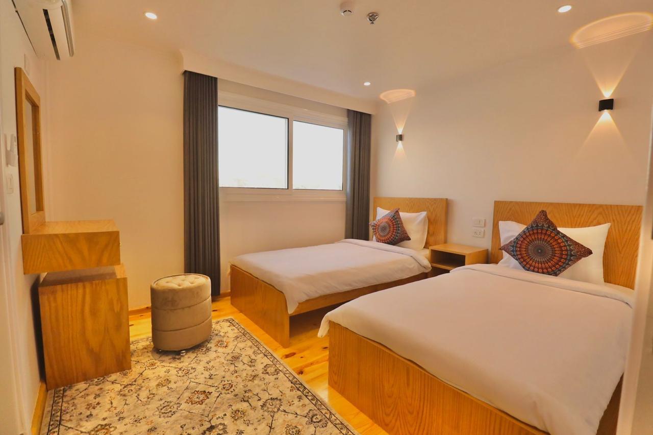 Twin cabin aboard the dahabiya with warm timber furnishings