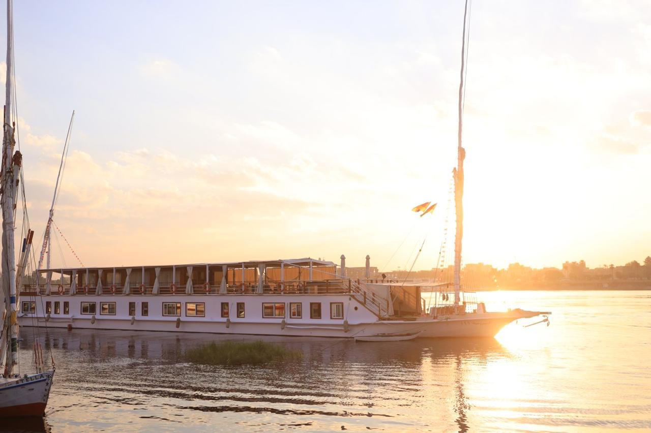 A dahabiya sailing boat glowing at sunset on the Nile