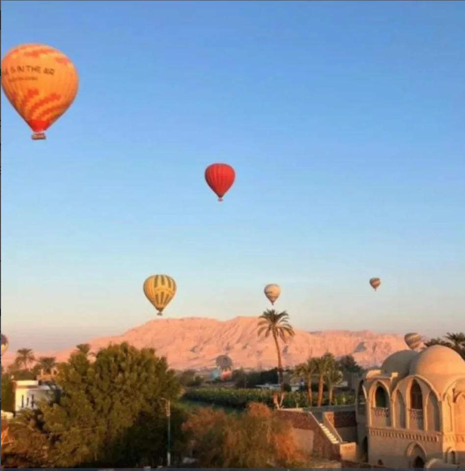 Hot-air balloons floating over Luxor at sunrise