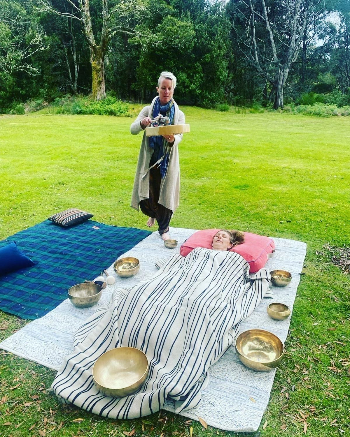 Mel offering an outdoor Tibetan singing bowl sound bath