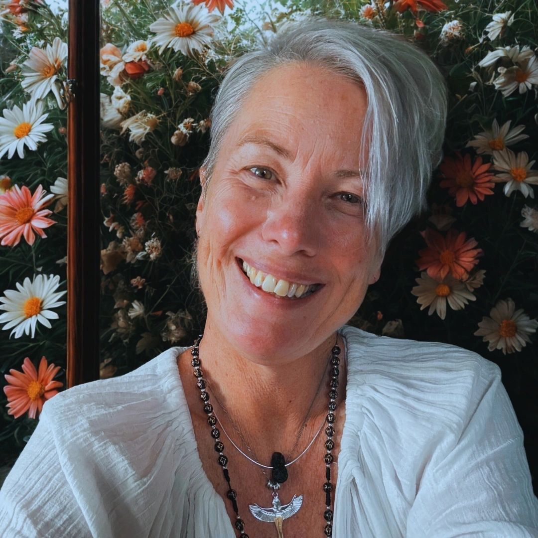 Mel Craven smiling in front of flowers