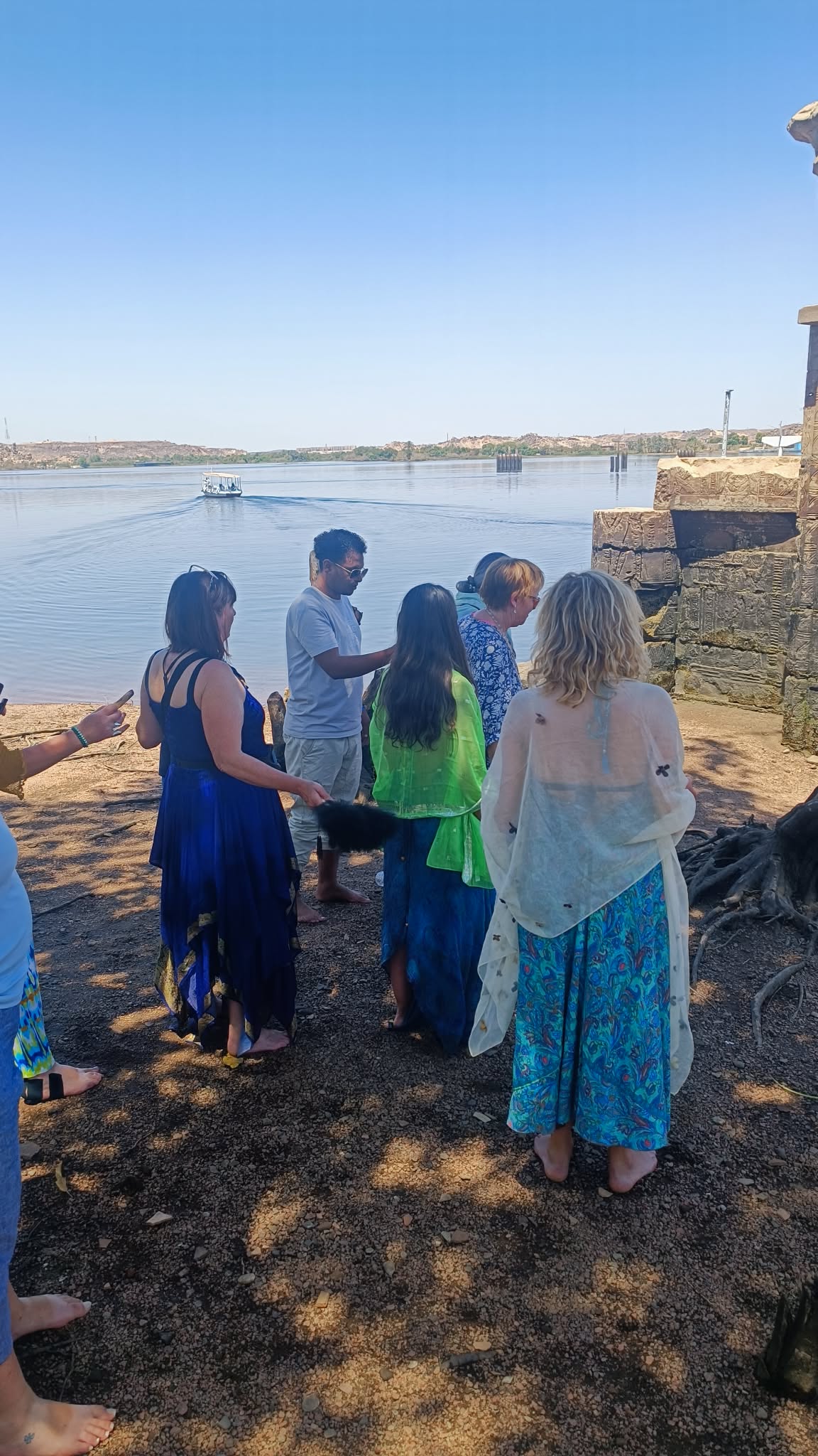Small pilgrimage circle gathered with a local Egyptian guide beside the waters of Philae