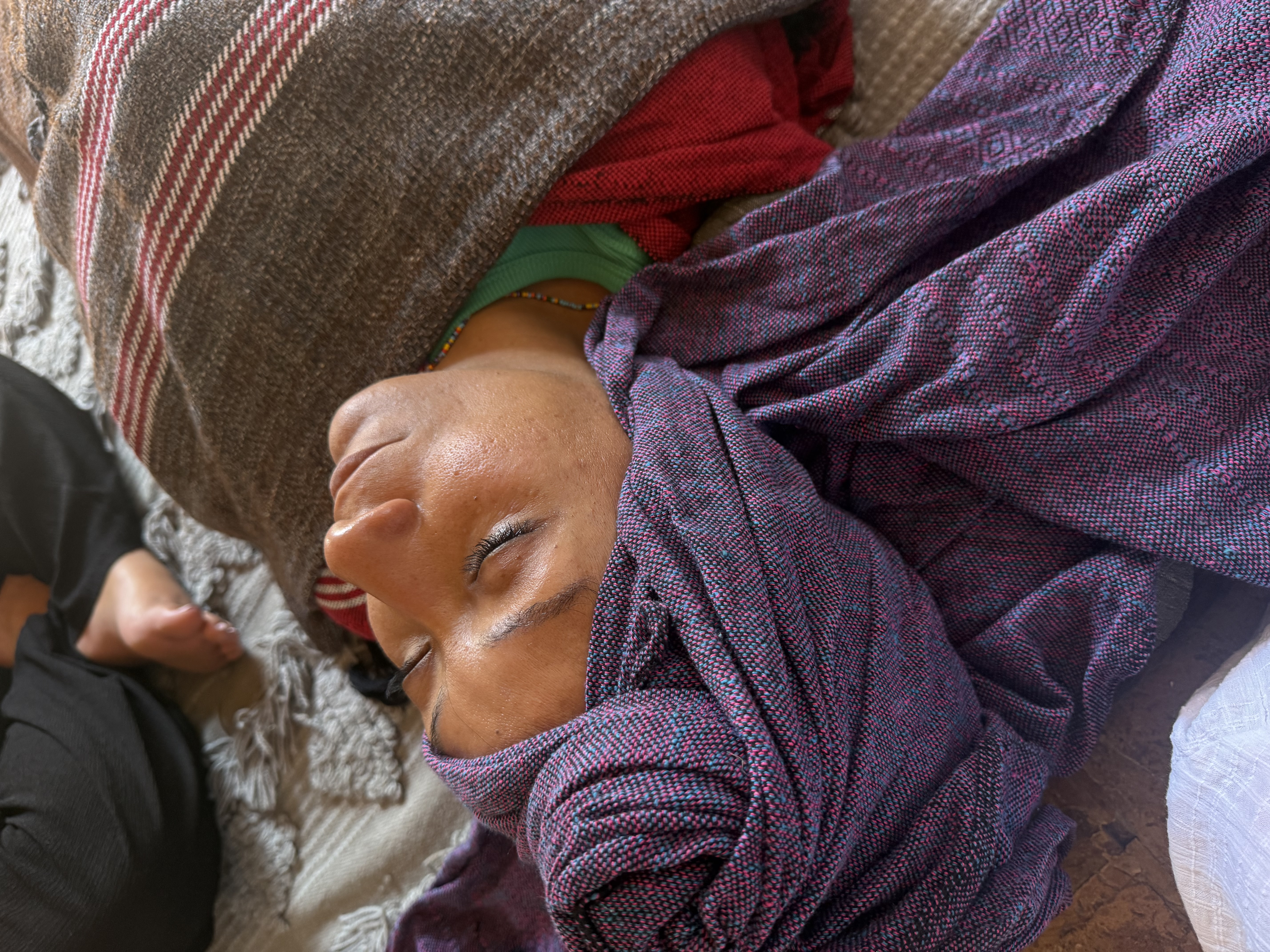 A woman resting and receiving care in ceremony